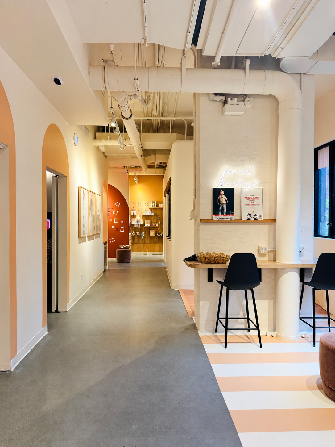 The lounge, with counter seating under the “for all the days” neon