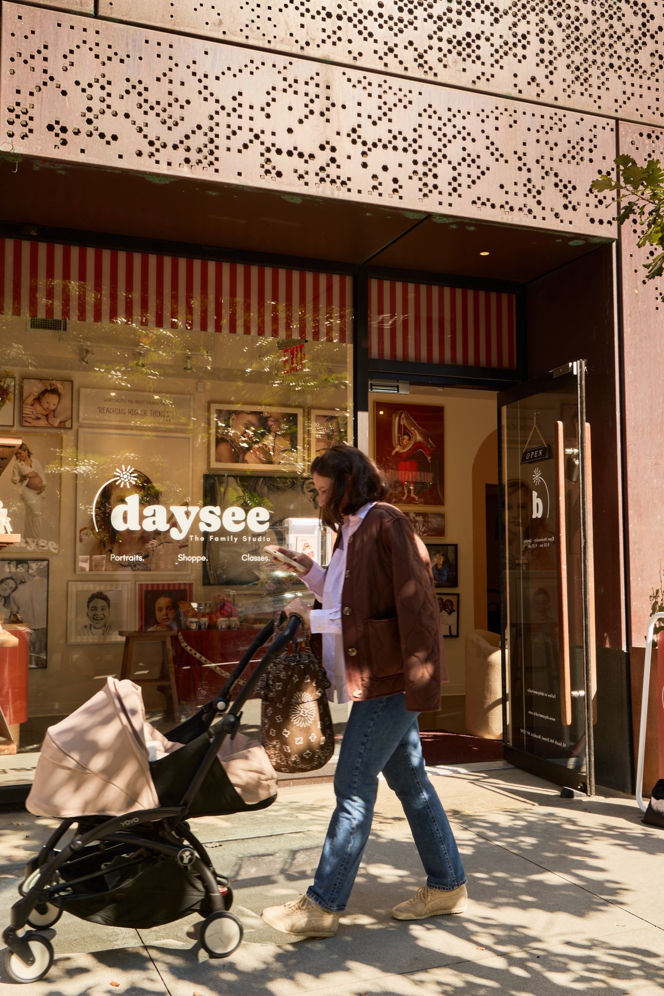 A guest arriving at the Daysee storefront with a stroller