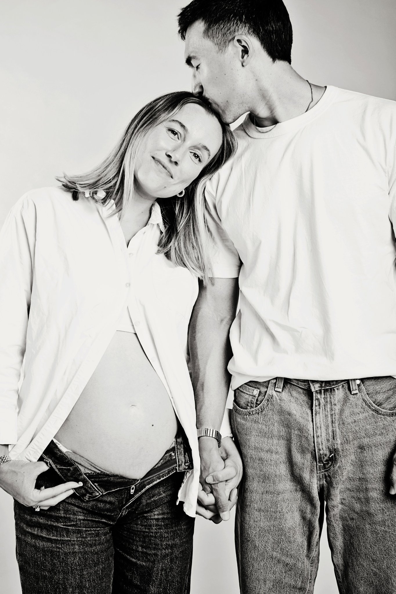 An expecting couple in black and white