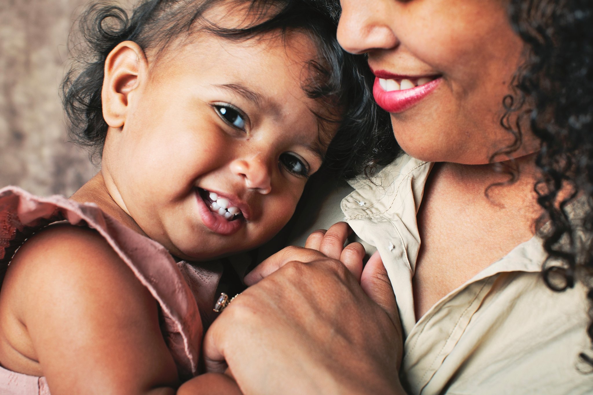 A mother and her baby cheek to cheek