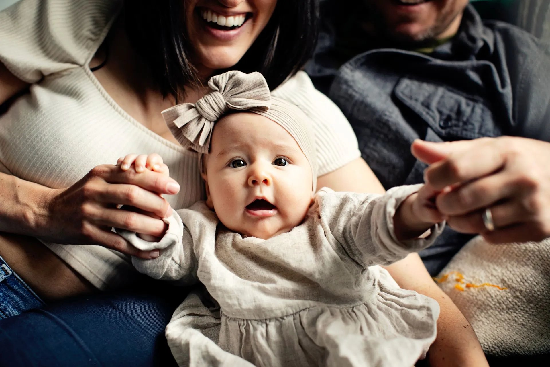 Parents laughing with their baby at home