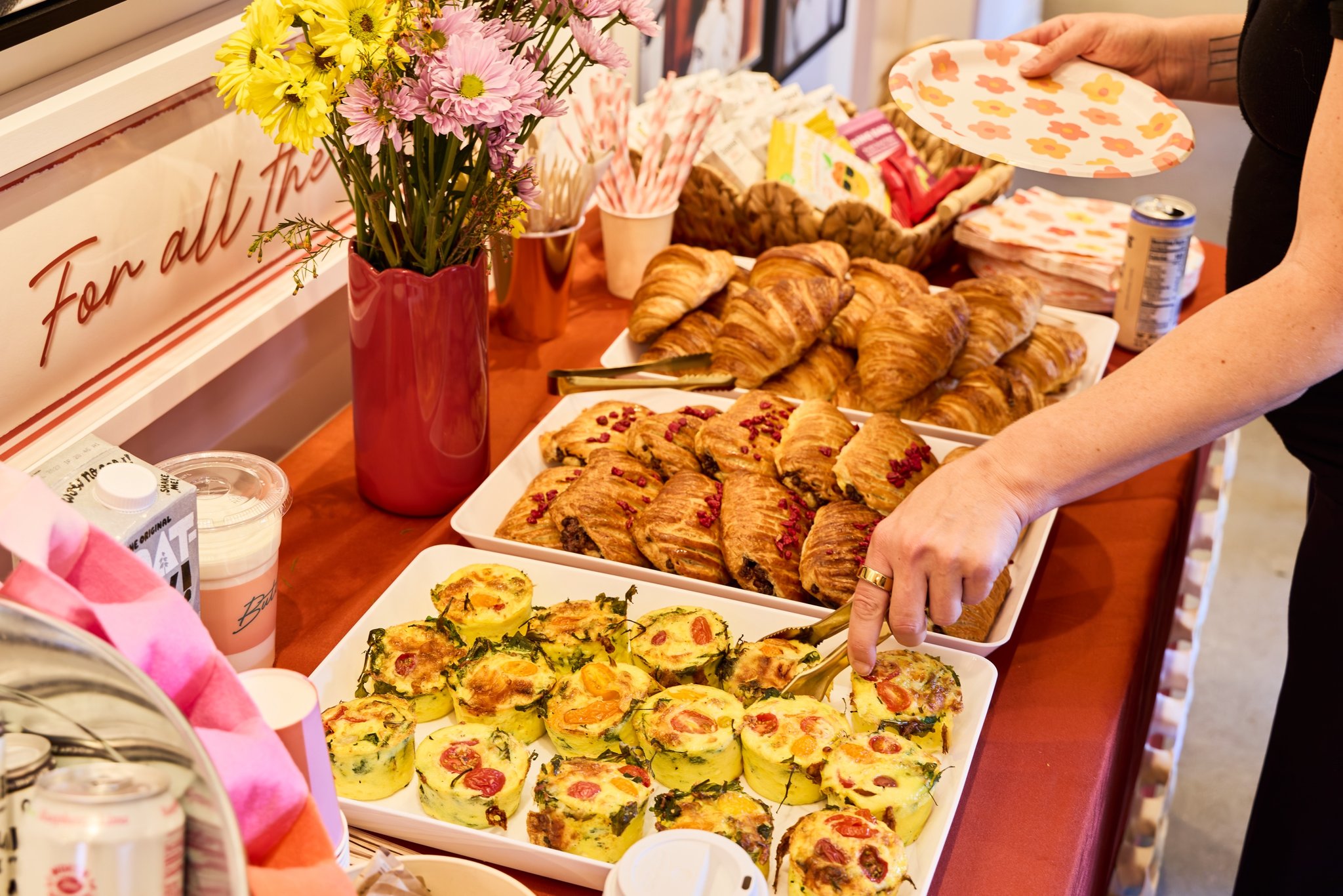 A spread of pastries and flowers on the party table