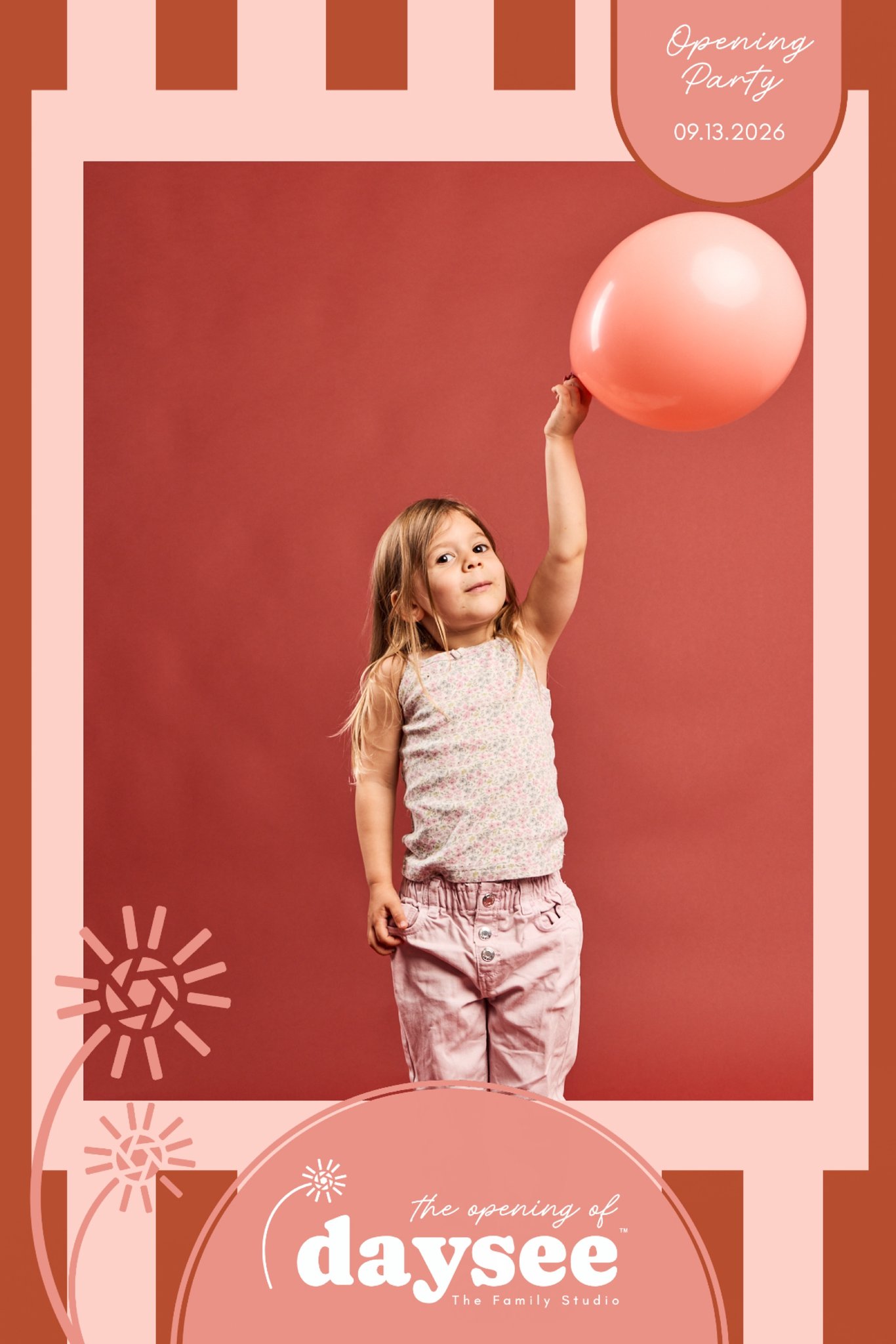 A girl reaching for a balloon in an instant-print party frame