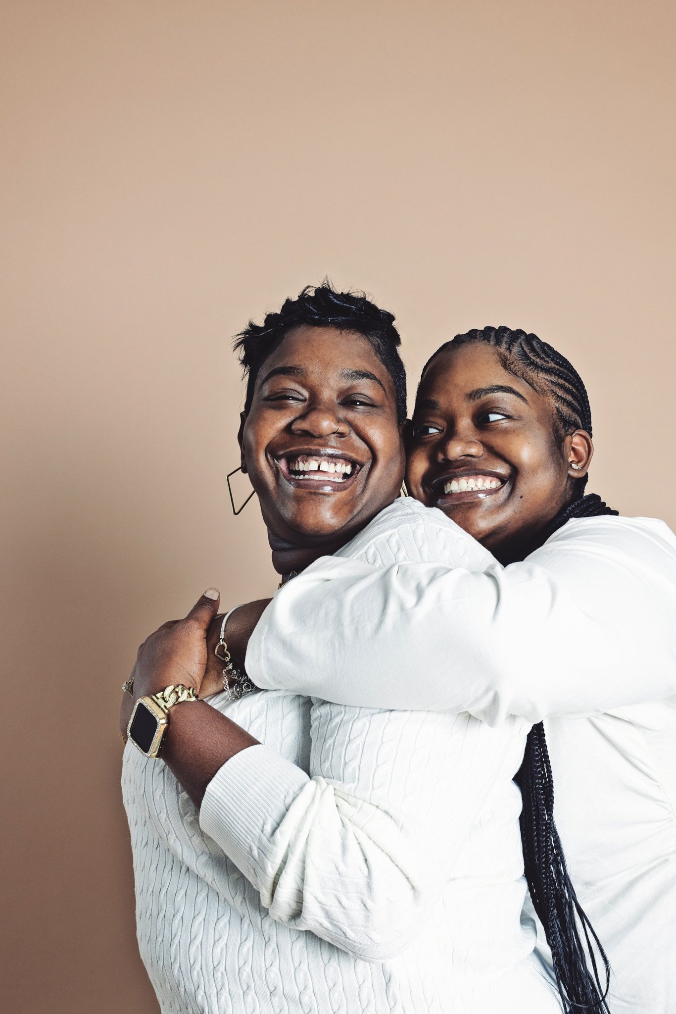 A mother and daughter hugging and laughing