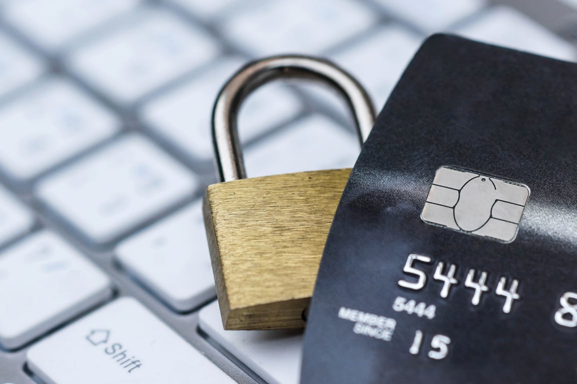 Padlock on credit card over keyboard, representing PCI and GDPR data security compliance for hotels