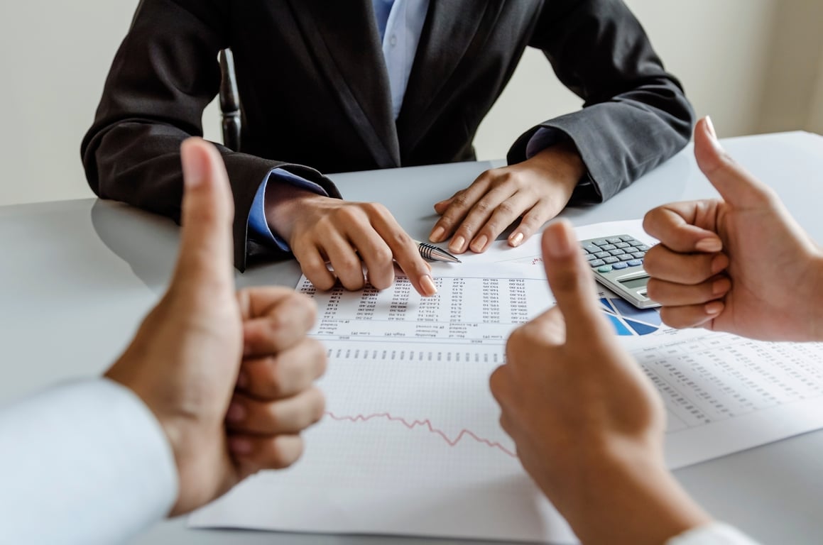 A team analyzing financial data to make revenue management decisions in the hospitality industry