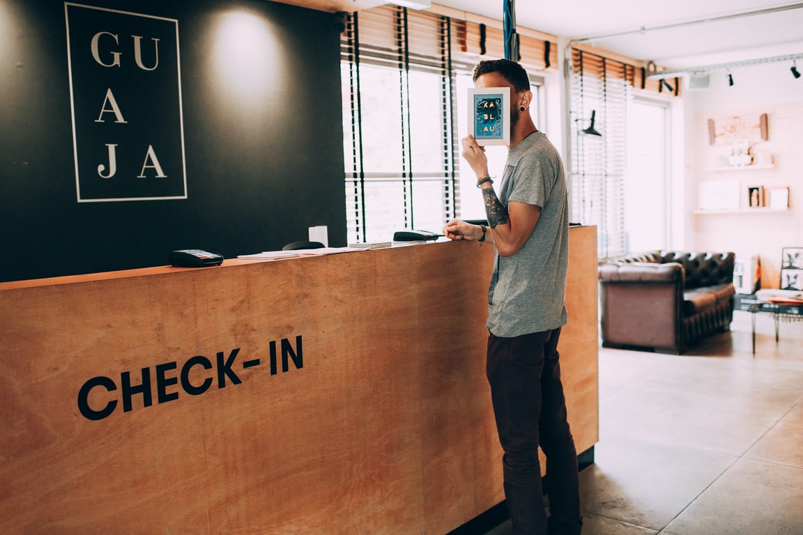 Guest standing at reception, hiding