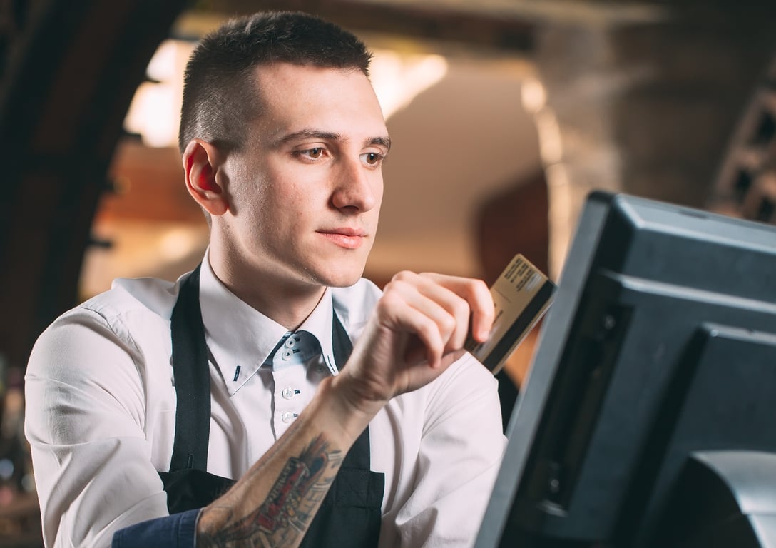 Cook using a restaurant management system to process paymen