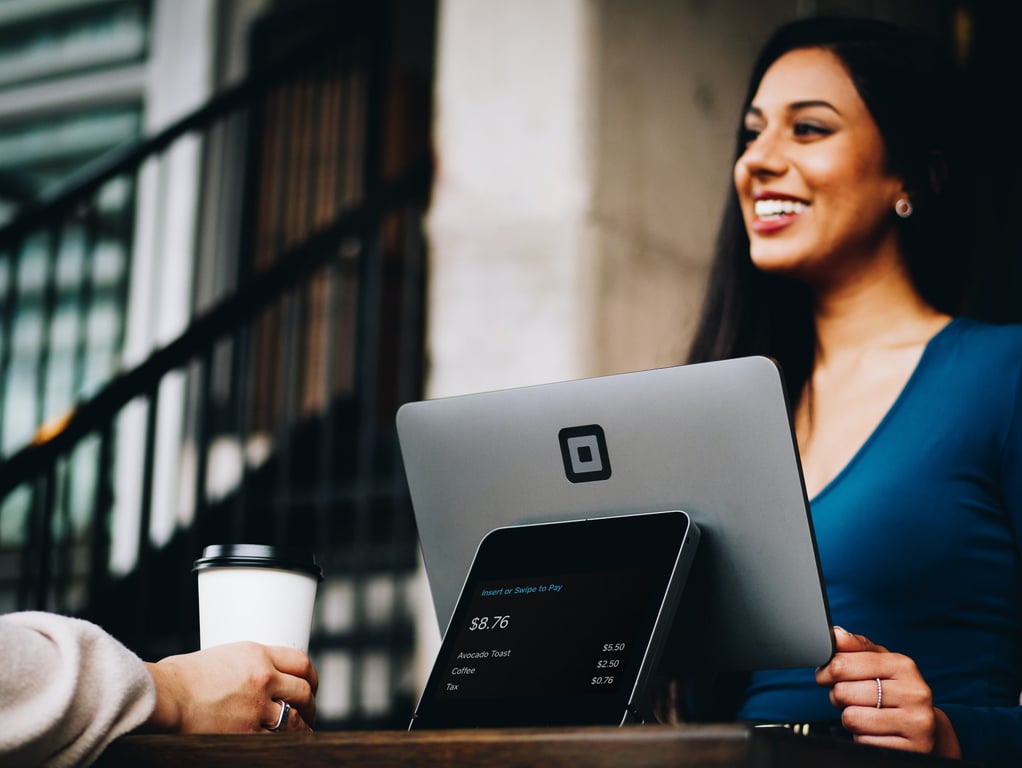 Guest paying for coffee at the reception of a hotel