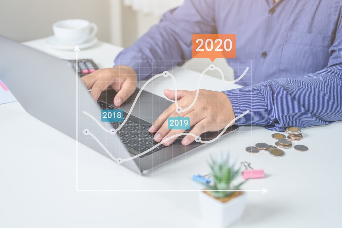 A man analyzing date-specific charts on a computer, representing custom forecasting models in hospitality
