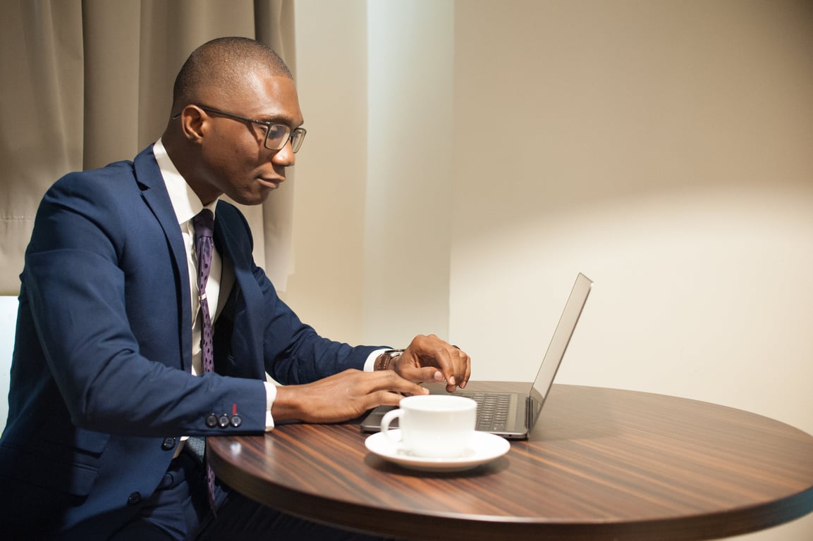 Man working from his laptop in an hotel room