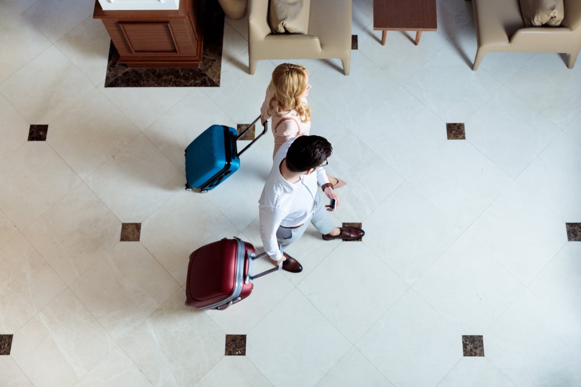 Couple and business traveler considering hotel upselling offers
