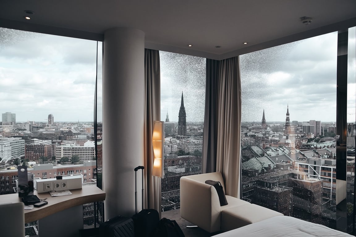 Floor-to-ceiling windows offering an expansive view of the city skyline, helping users and search engines understand its urban luxury appeal.