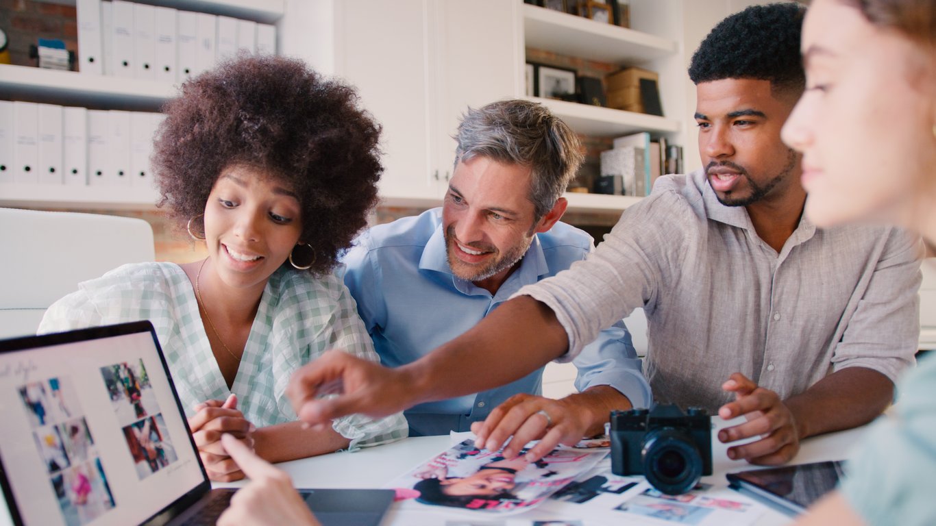 A laptop displaying a hotel website with vibrant images and blog posts, managed by a hotel content marketing agency.