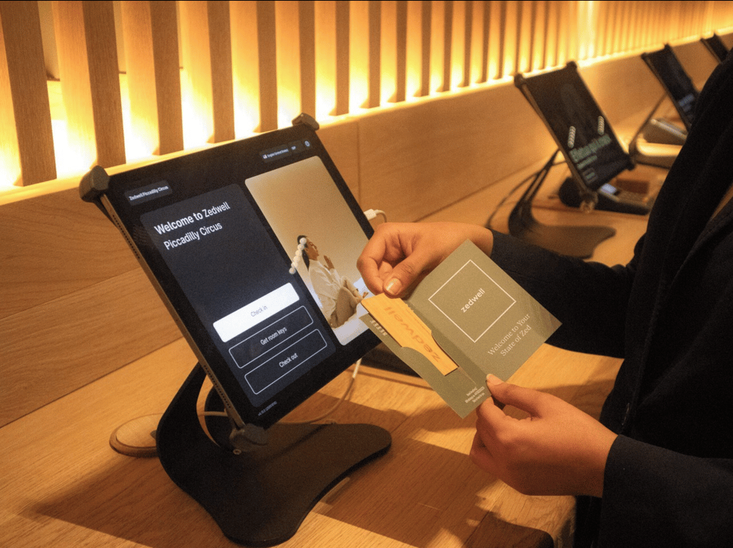 Hotel automation in action: Space for interacting with self-service kiosks and digital interfaces in a sleek hotel lobby.