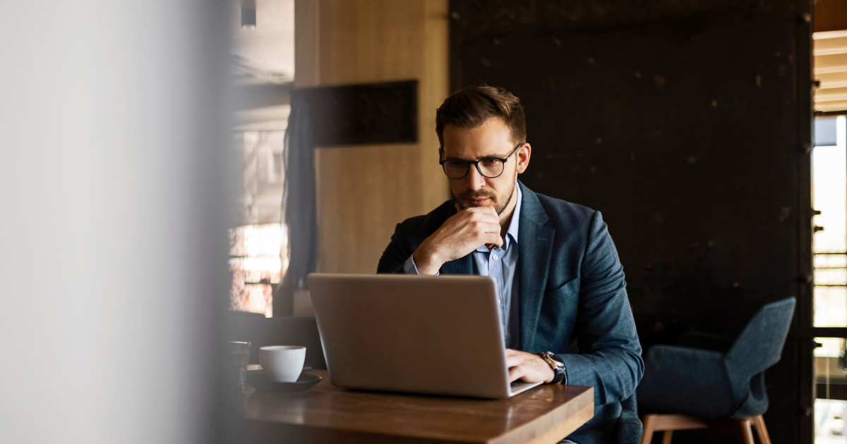 Hotel revenue manager analyzing data on laptop while developing commercial strategy