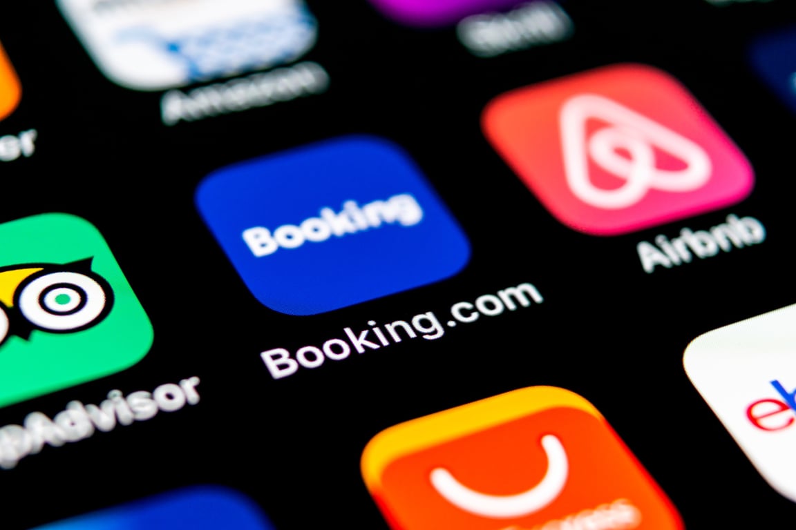 Person comparing hotel booking apps on a smartphone