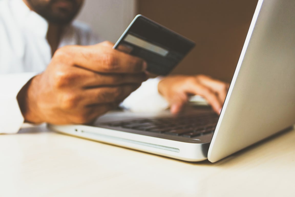 paying on computer with a card.
