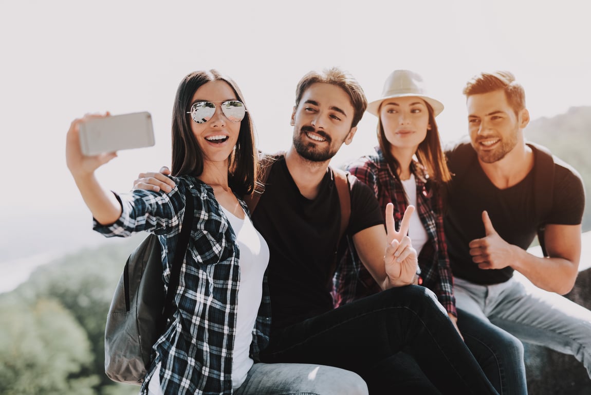 Group of happy millennials taking a selfie outdoors