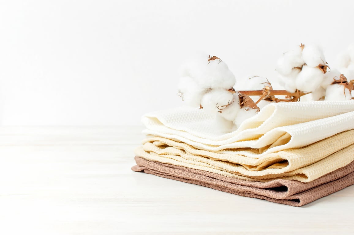 Stack of organic cotton towels representing sustainable textile options in the hospitality industry