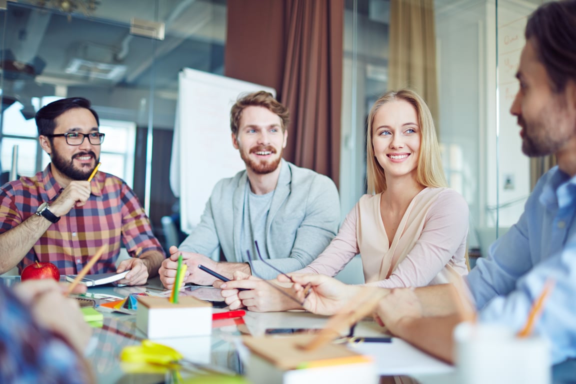 Group of hospitality consultants discussing strategies in a meeting room
