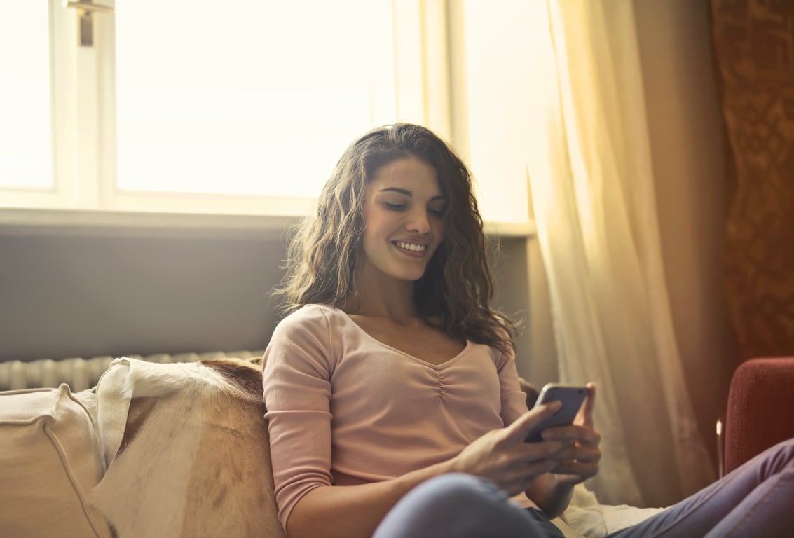 A guest using a smartphone to interact with a hotel