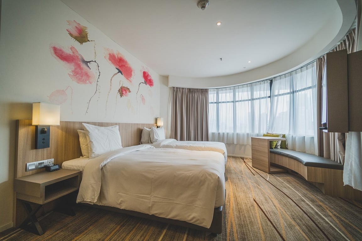 A beautiful hotel room with a semi-circle windowscape