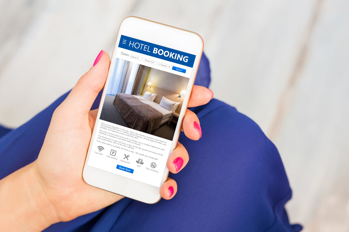 A guest securing a last minute hotel deal on a mobile phone