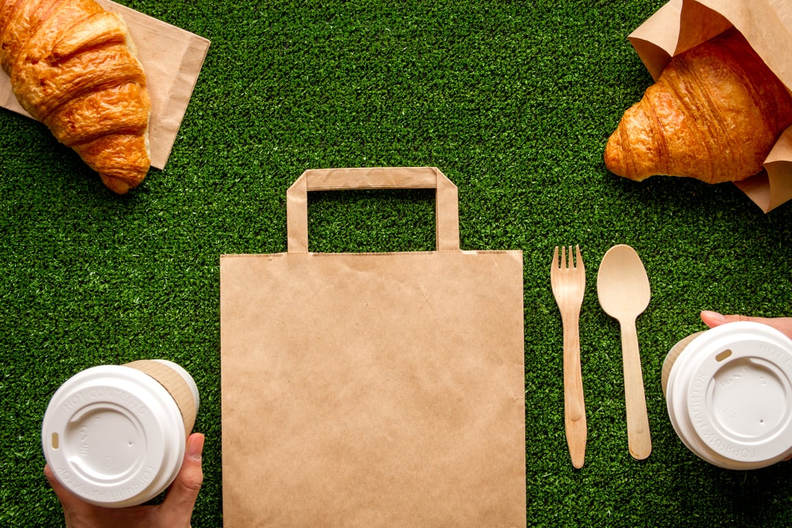 Biodegradable take-away packaging on an eco-friendly backdrop