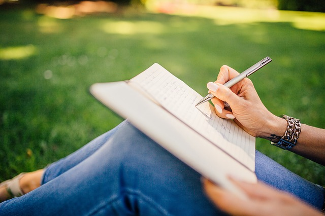Person writing in a book