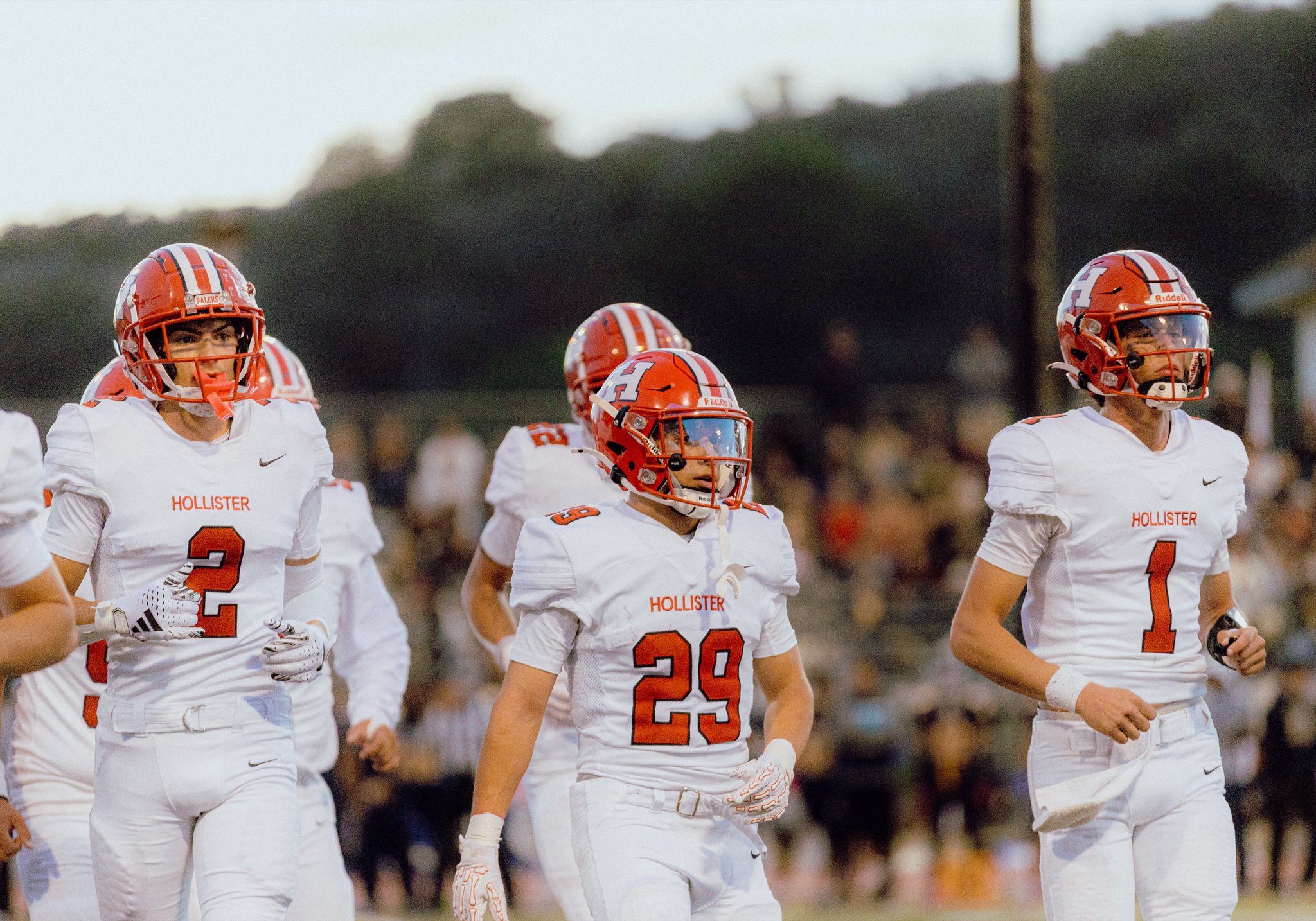 Football players walking the sideline