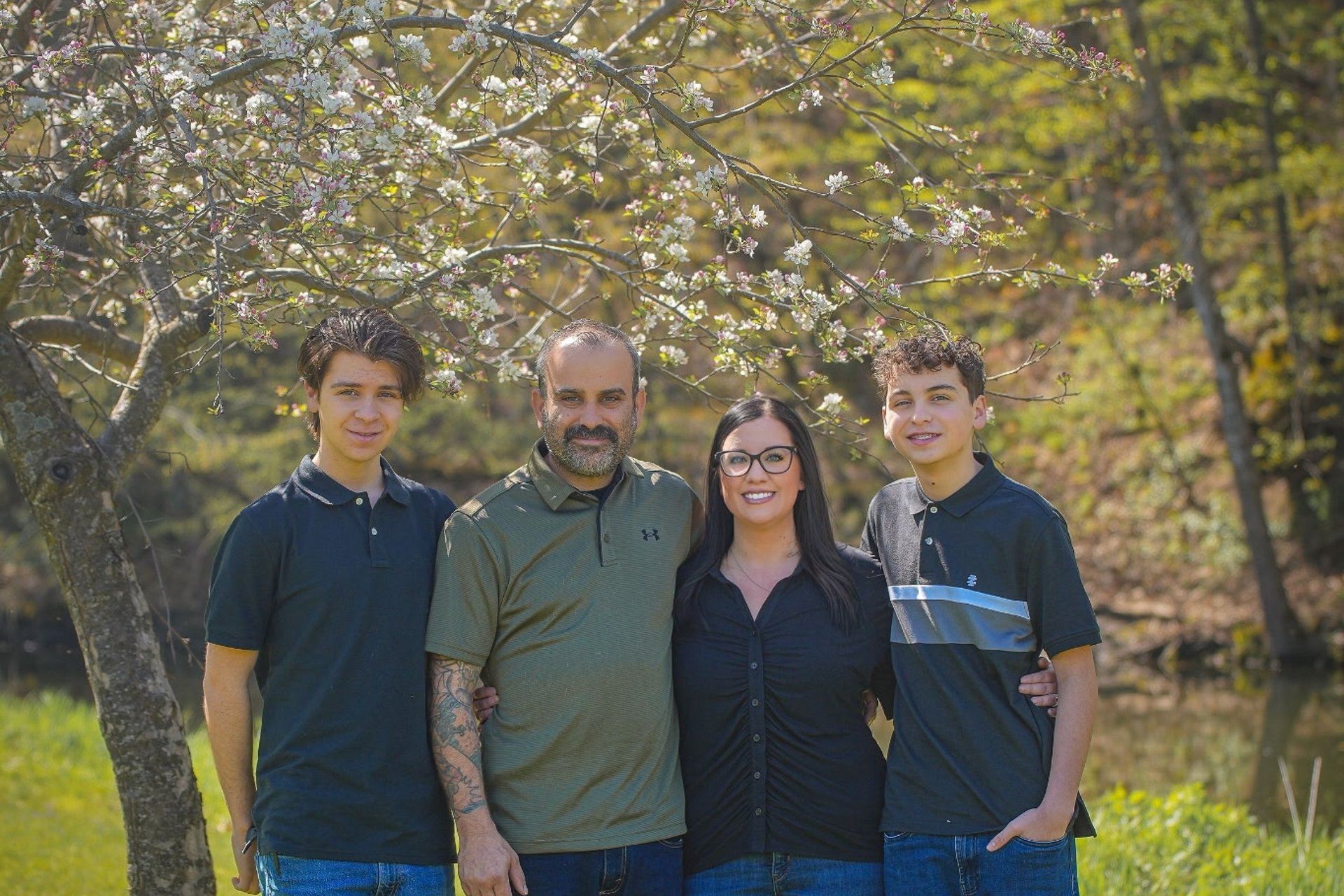 The family-owned Andrew's Pro Clean team outdoors under a blossoming tree in southern Minnesota