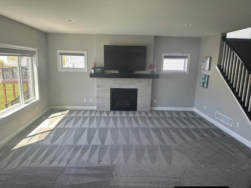 Freshly cleaned living-room carpet beside a fireplace in an Owatonna, MN home
