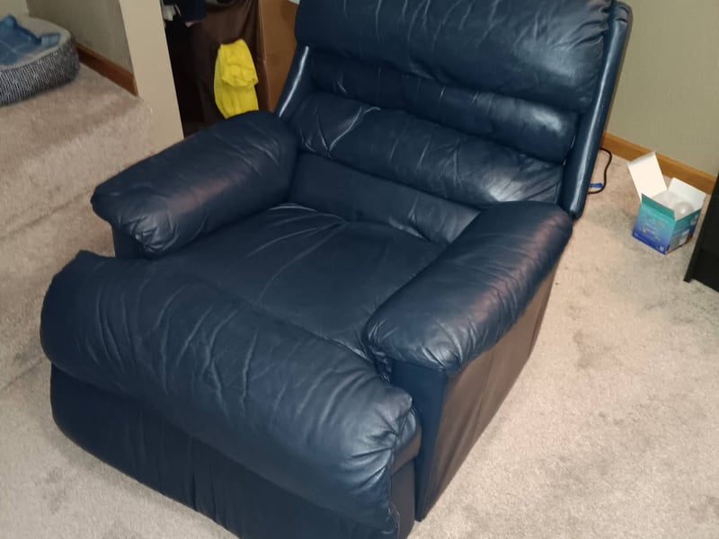 The same blue leather recliner cleaned and conditioned, color restored and creases freshened