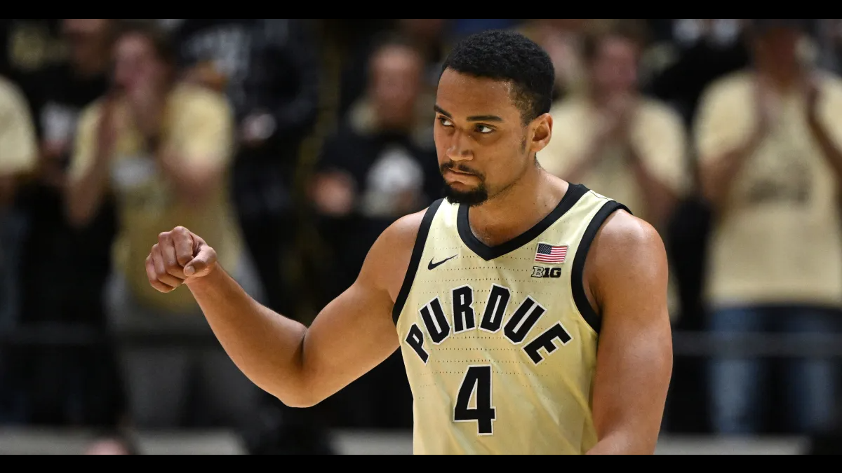 Trey Kaufman-Renn in a gold Purdue number 4 jersey clenching his fist after a play