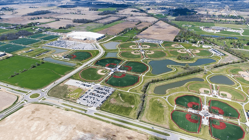 Aerial view of a large Indiana sports complex with rows of athletic fields and ponds