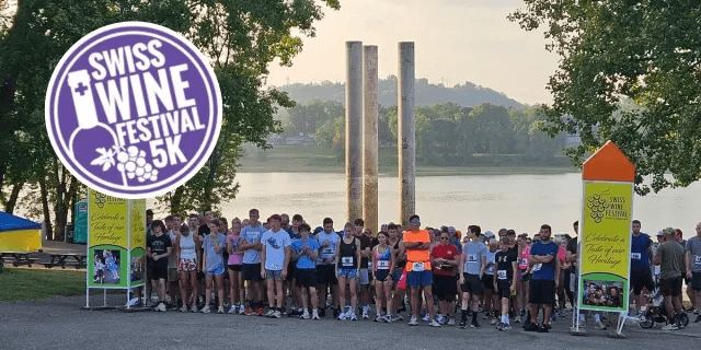 Runners lined up at the start of the Swiss Wine Festival 5K along the Ohio River in Vevay, Indiana