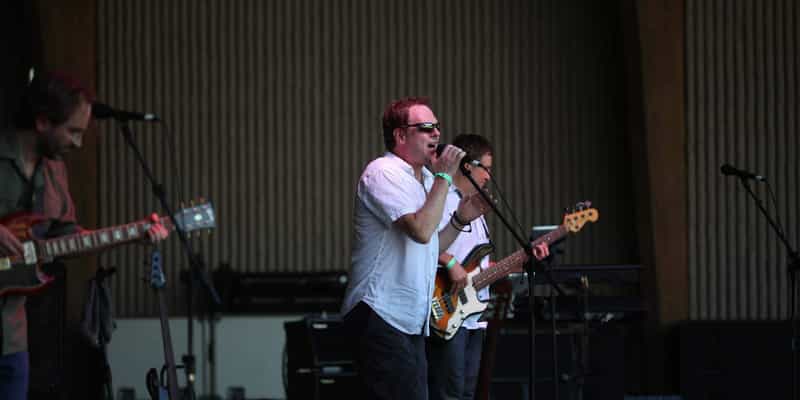 A band performing on stage at the Greenwood Freedom Festival