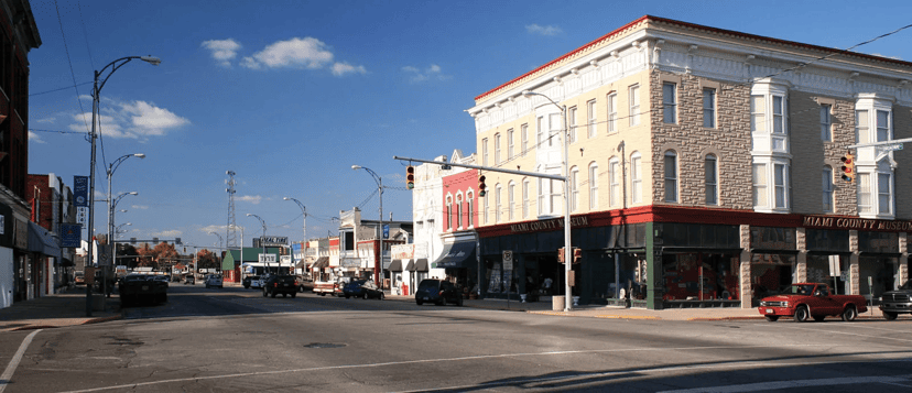 A quiet downtown street intersection in Peru, Indiana, lined with historic buildings