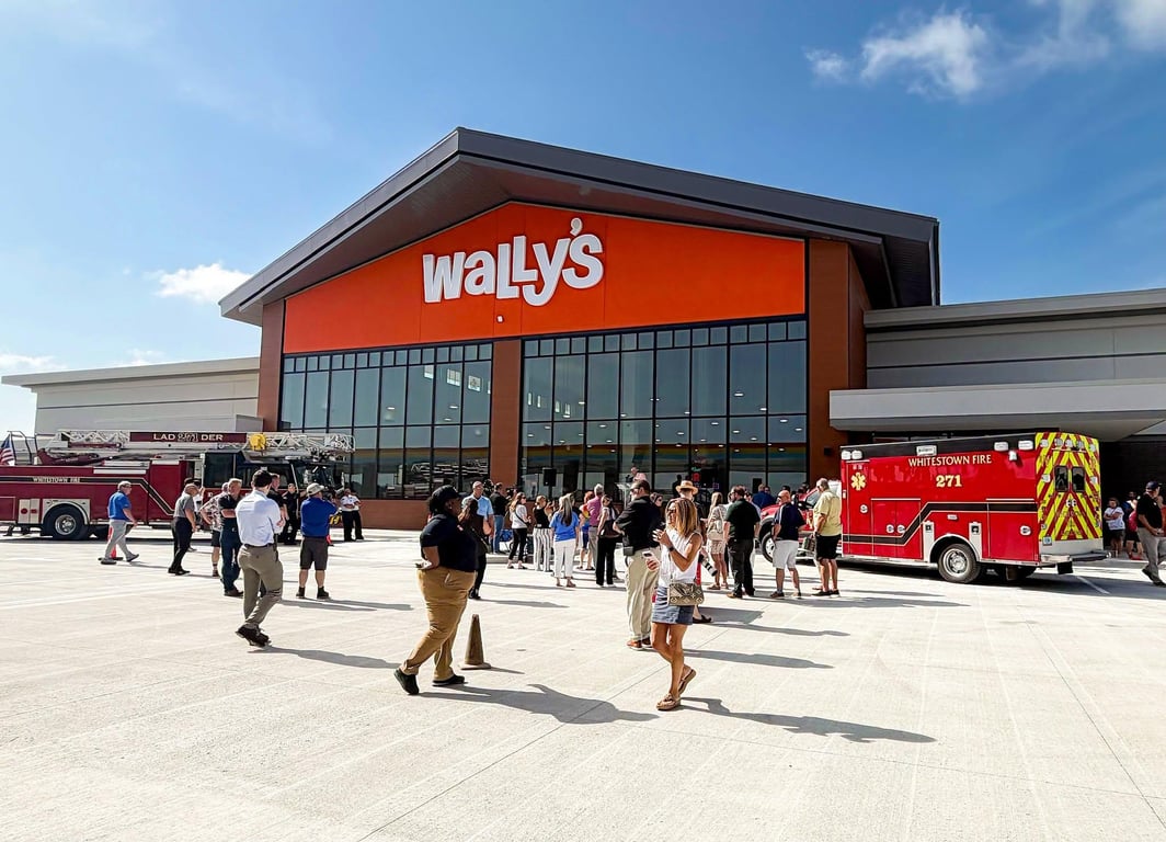 Crowd gathered outside the new Wally’s travel center in Whitestown on opening day, with two Whitestown Fire trucks parked at the entrance
