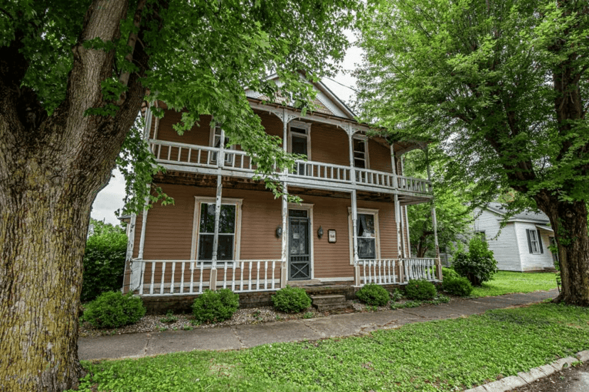 Two-story Roads Hotel in Atlanta, Indiana, with a wraparound porch