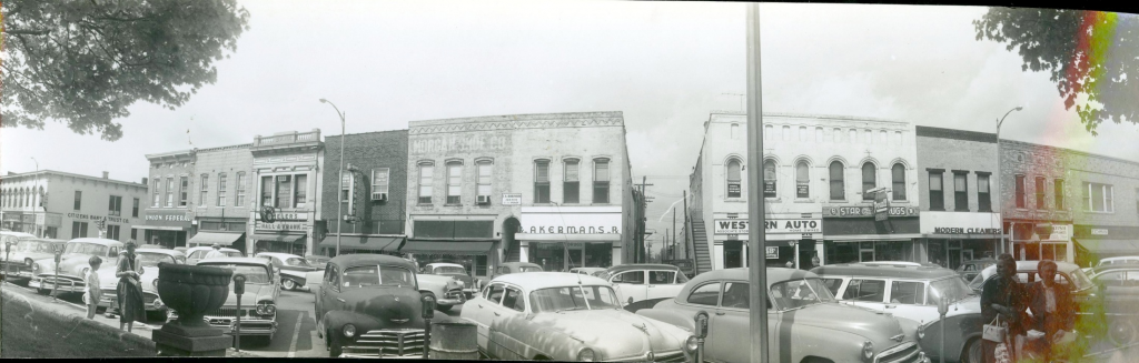 Vintage black-and-white panorama of downtown Lebanon, Indiana storefronts, including a Western Auto store, with 1950s cars parked along the street