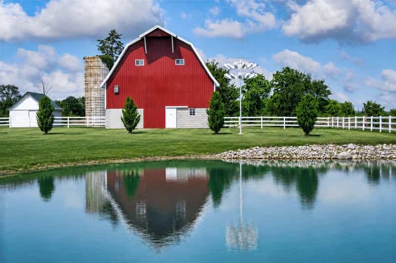Red barn reflected in a pond at Woolly Yak Ranch & Winery in Arcadia