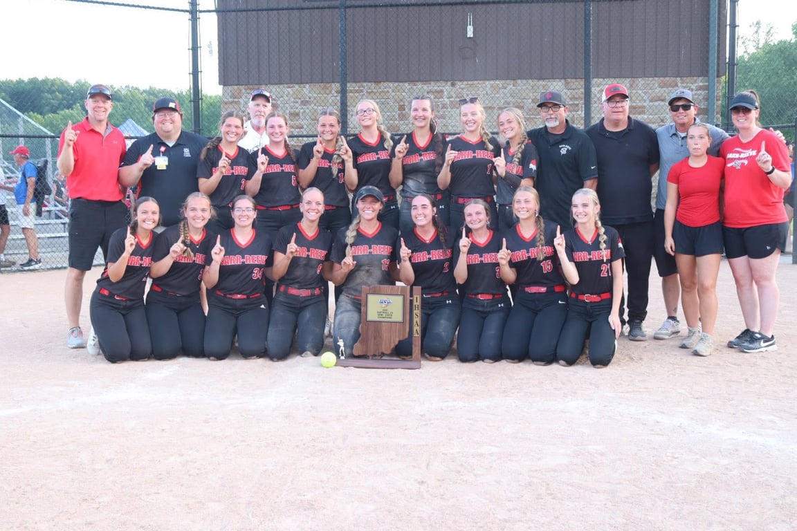 The Barr-Reeve Lady Vikings softball team celebrates with its semi-state championship trophy.