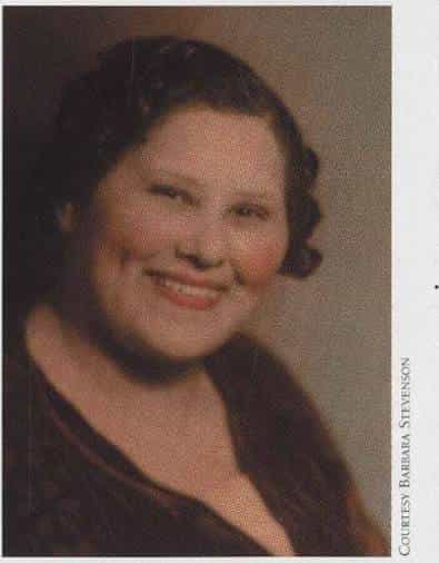 Hand-tinted portrait of Katherine "Flossie" Bailey smiling, with dark curled hair and a dark top