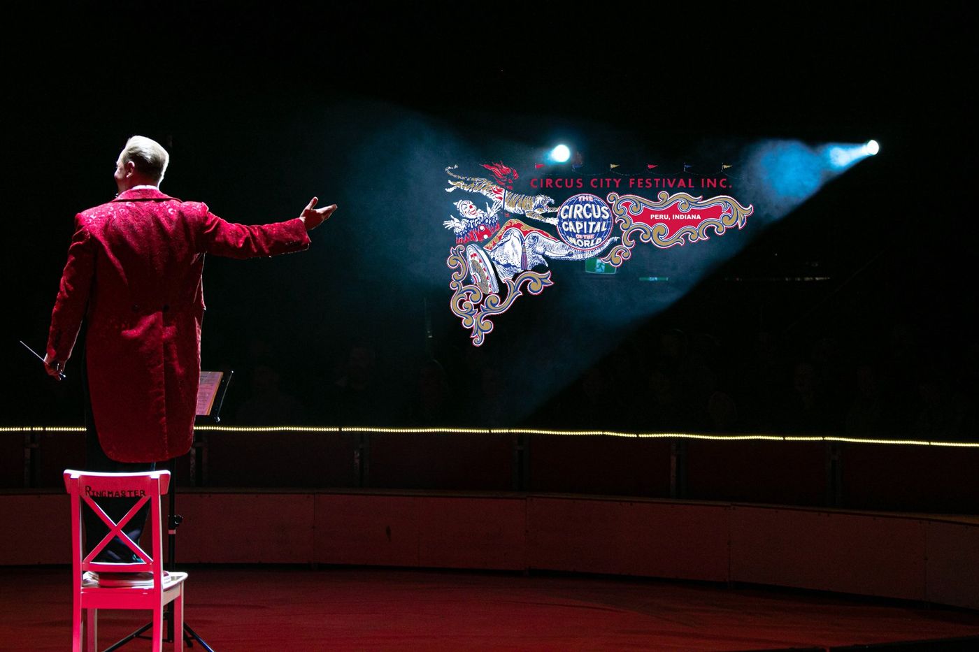 A ringmaster in a red sequined coat presents the Circus City Festival in the big-top ring in Peru, Indiana