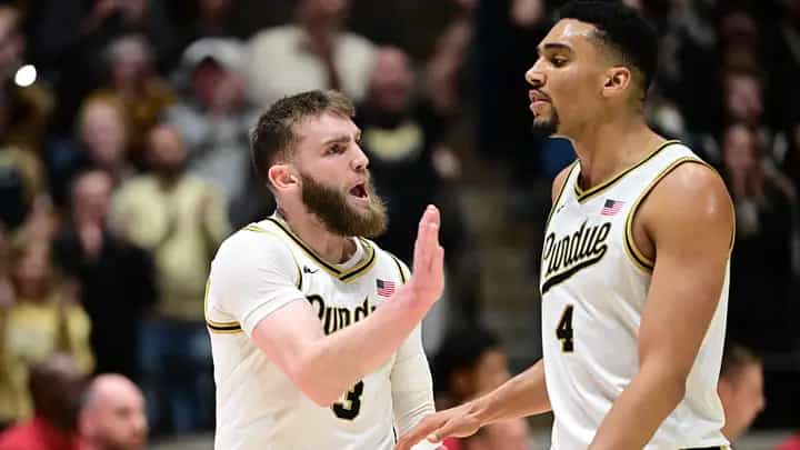 Purdue guard Braden Smith and forward Trey Kaufman-Renn in white Purdue jerseys reacting together during a home game