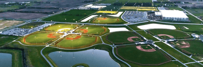 Aerial view of a sprawling Indiana sports complex lined with baseball and softball diamonds