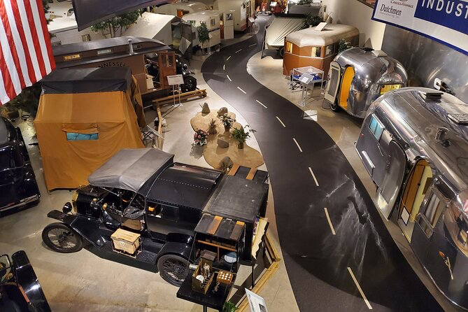 Vintage campers and an early auto camper on display inside the campground-style Founders Hall at the RV/MH Hall of Fame in Elkhart, Indiana.