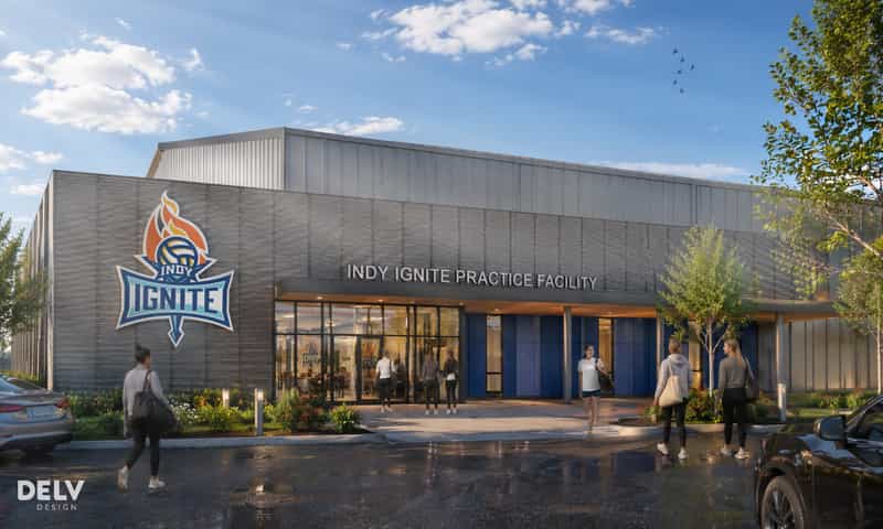 Rendering of the Indy Ignite practice facility exterior in Fishers, with the team logo on the gray facade and visitors walking toward the entrance
